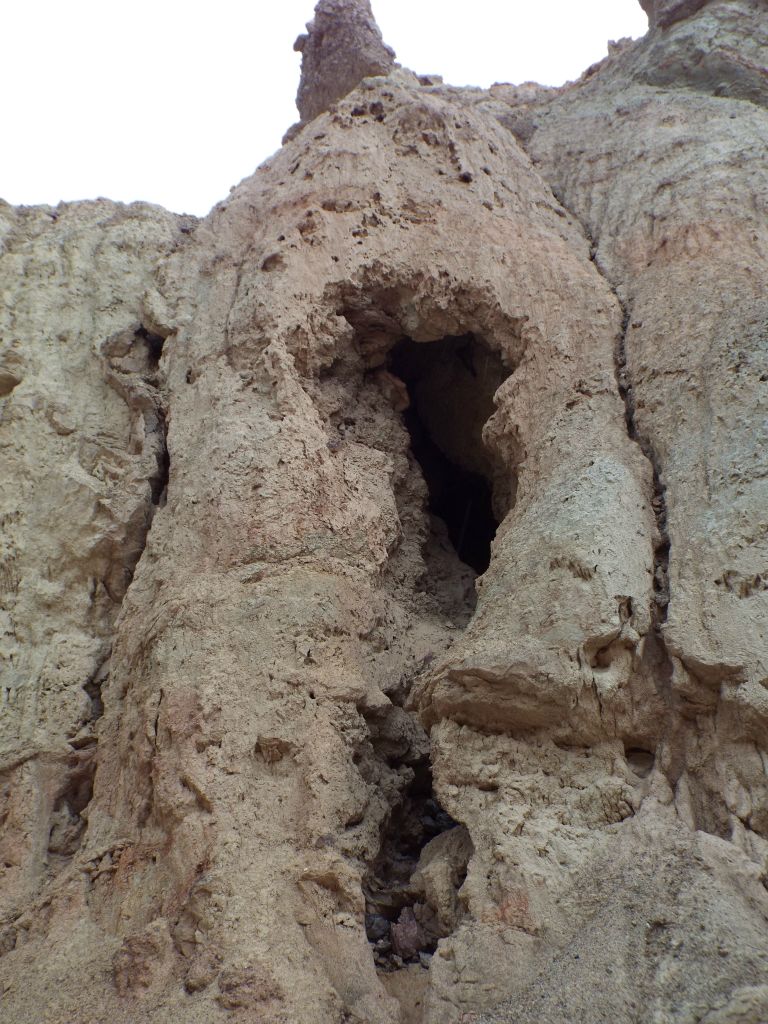 Upon climbing up to take a closer look, I discovered that the opening was not a cave but a full natural tunnel which passes through the canyon wall (or hillside):