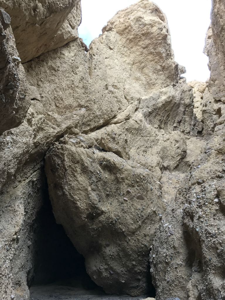 Sections of the canyon wall have collapsed and formed a dark passage to enter into: