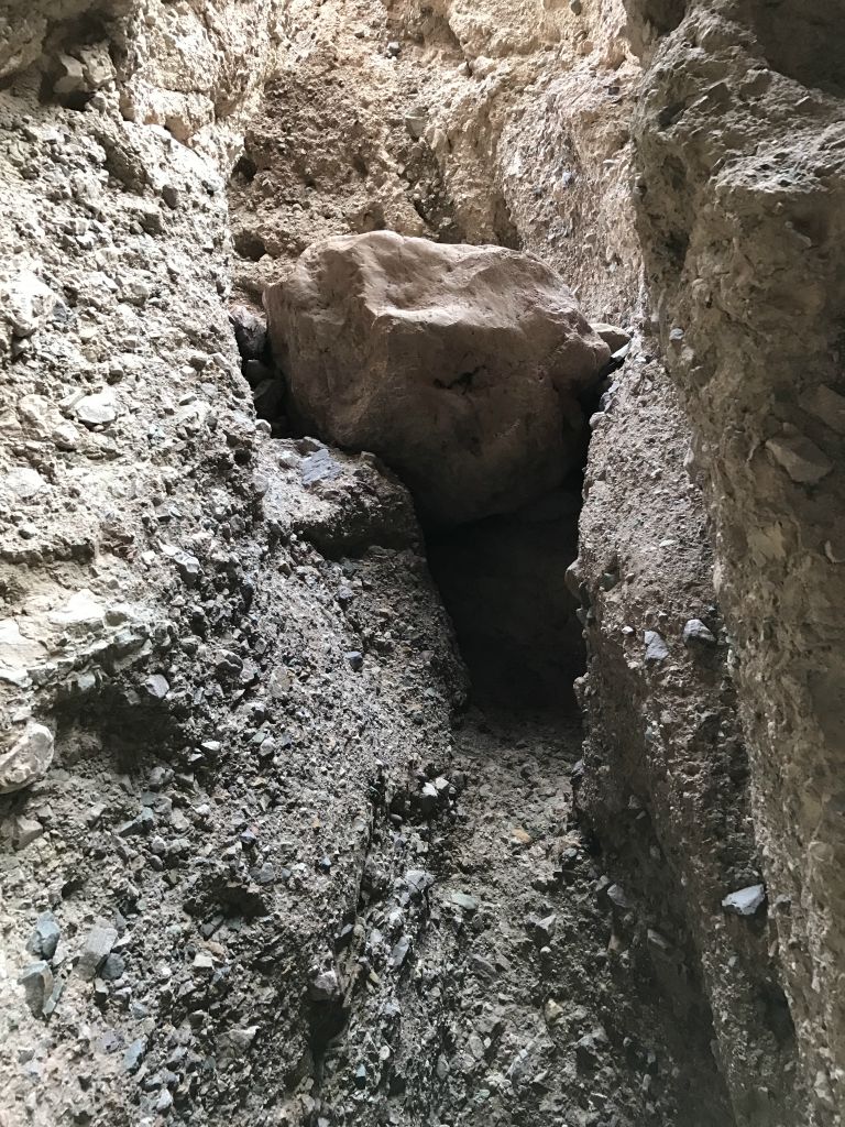 As seen here, a large solid rock boulder sticks out over the rim of the dry fall, making climbing past it challenging: