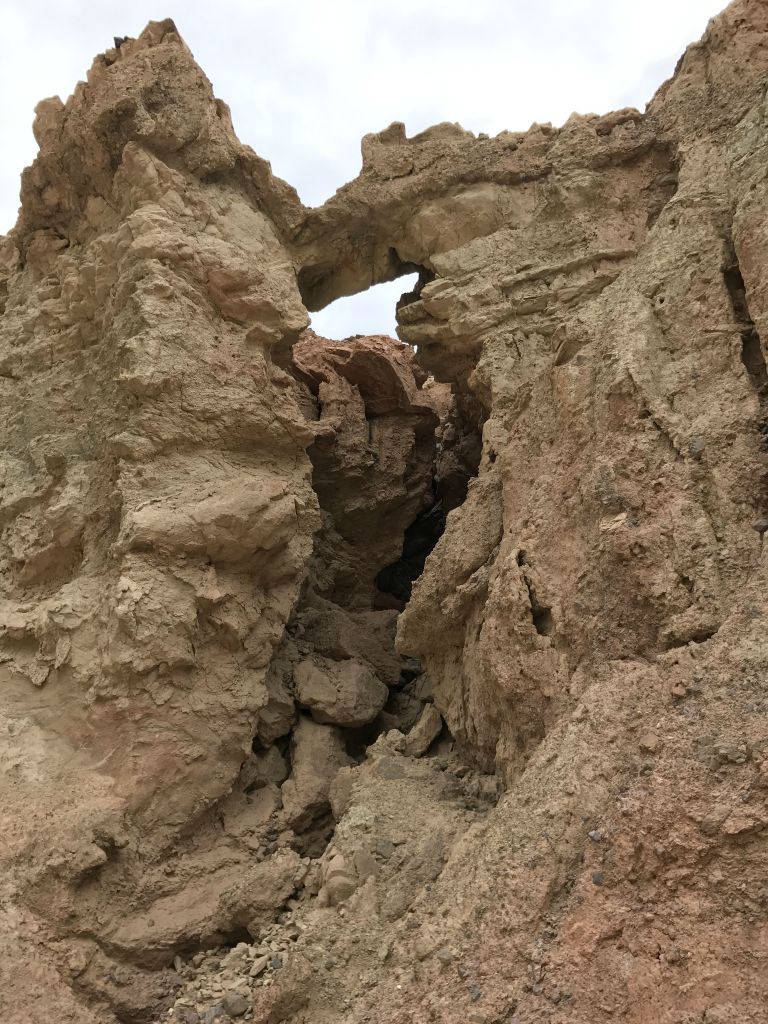 Crown Natural Bridge can be found about halfway through the canyon on the right side: