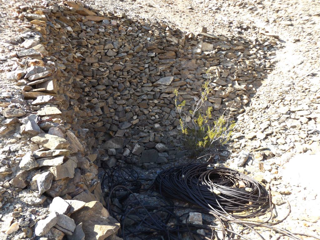 This sheltered area with a rock wall was likely built to be more than just a cable storage area:
