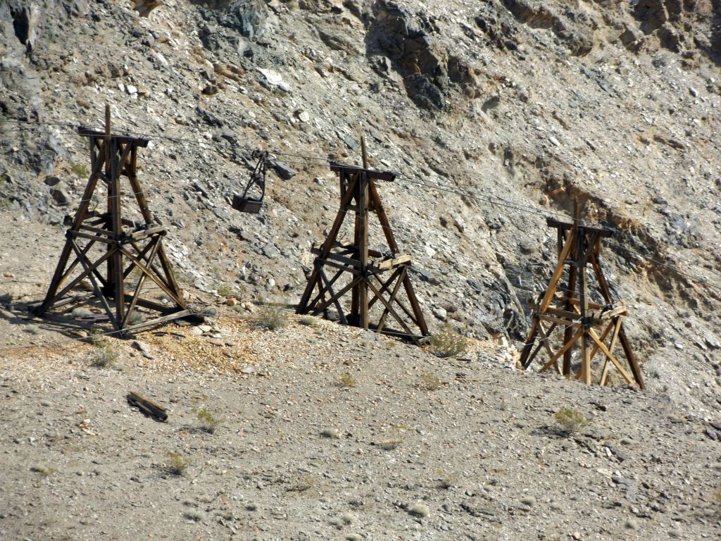 Zooming in on an area where the tramway line crosses the canyon as it descends.  Notice the ore bucket visible which is hanging from a cable:
