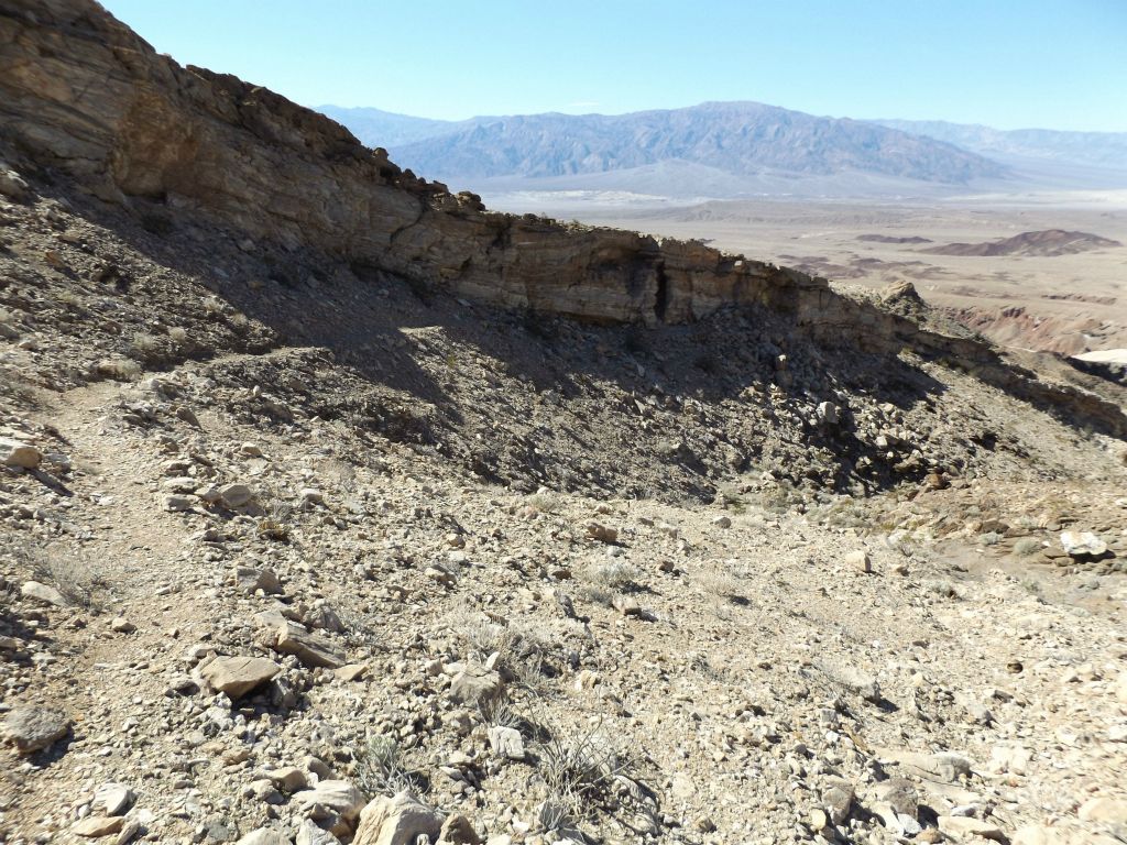 Looking back at the trail as it passed beneath the rock wall: