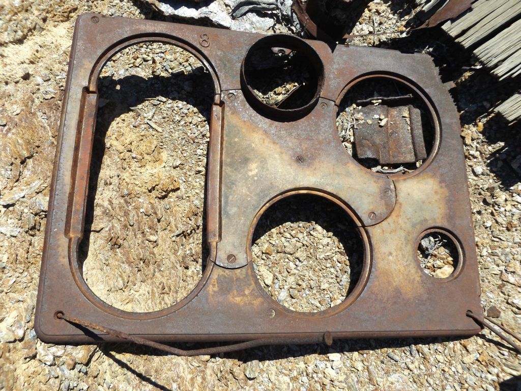 The metal frame of a stovetop used long ago for cooking meals: