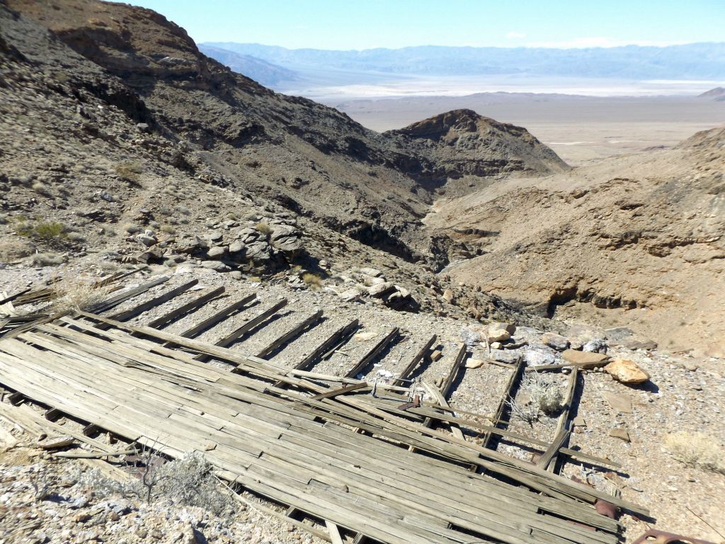 View from the wooden platform showing the trail, overlook point, and canyon below: