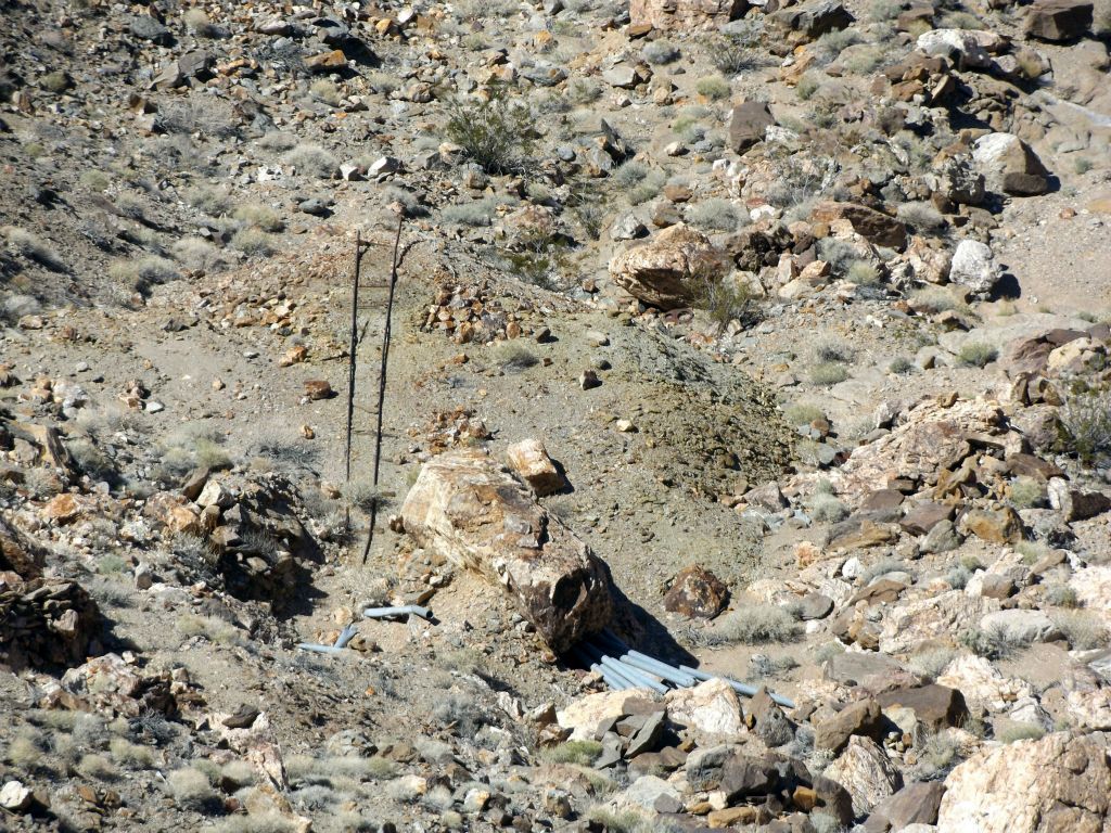 Our last look down into the canyon revealed a tall ladder and some pipes in the wash: