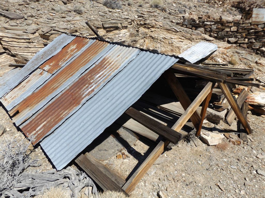 The living area of Big Bell is now reached.  Winds have collapsed this first shack and now only the roof is intact.  These structures were possibly constructed as early as 1907 by the Big Bell Mining Company: