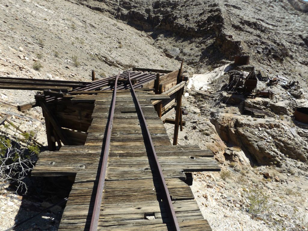 Outside of the mine, cables still stretch between the mine and mill far below.  You can also see the cable road to Chloride Cliff in the distance: