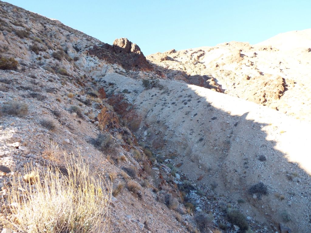 Wrong.  We hiked a little farther and got blocked by this giant trench.  It seemed like we had made a mistake by hiking up the ridge on the left rather than staying far below in the center gully (out of view on the right):