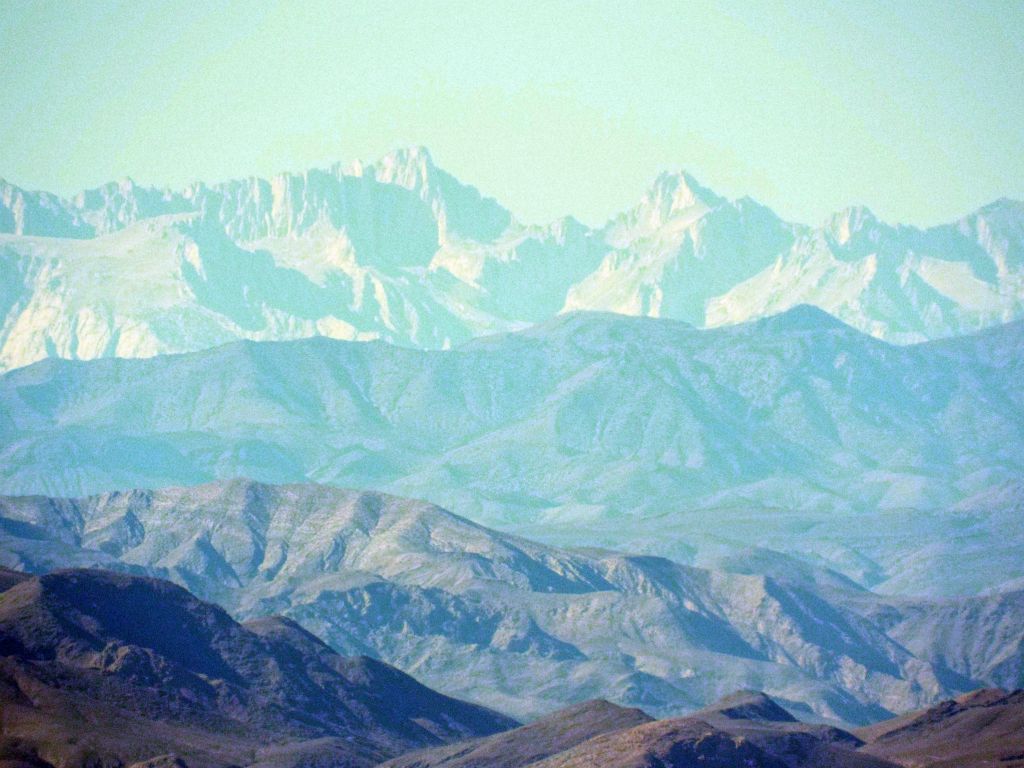 The left peak is Mount Whitney, which is approximately 95 air miles away.  The peak on the right is Mount Russell: