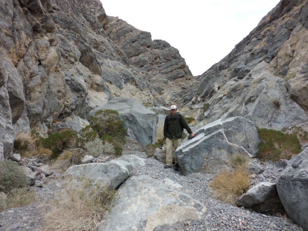 A picture of Steve near the beginning of Rockfall Canyon posing next to some rockfall: