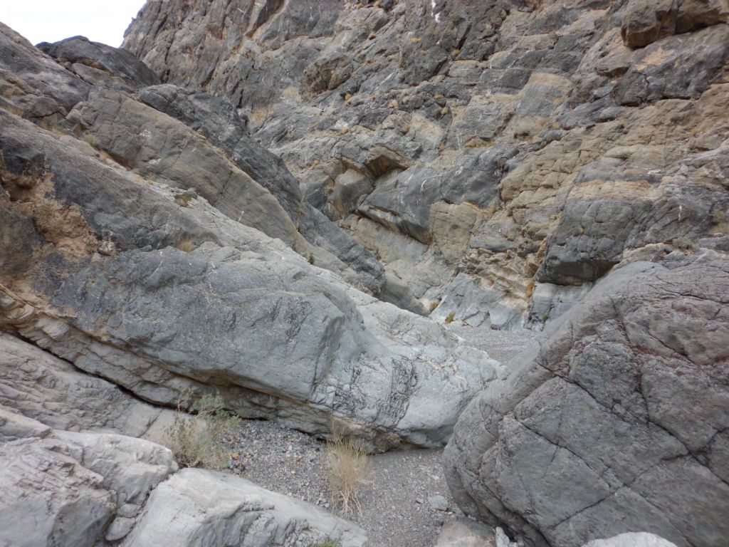 Navigating through the narrows with opposing rock walls nearly touching at the bottom: