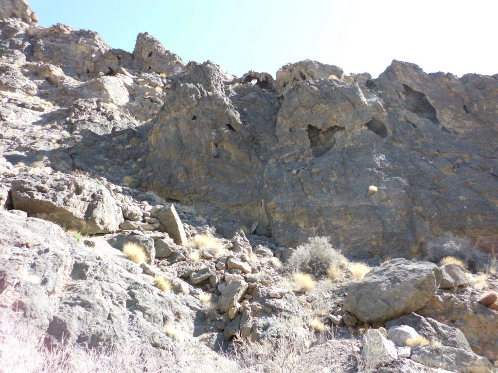 The scenery up on the hillsides now caught our attention with these natural rock caves and an arch seen at the top middle: