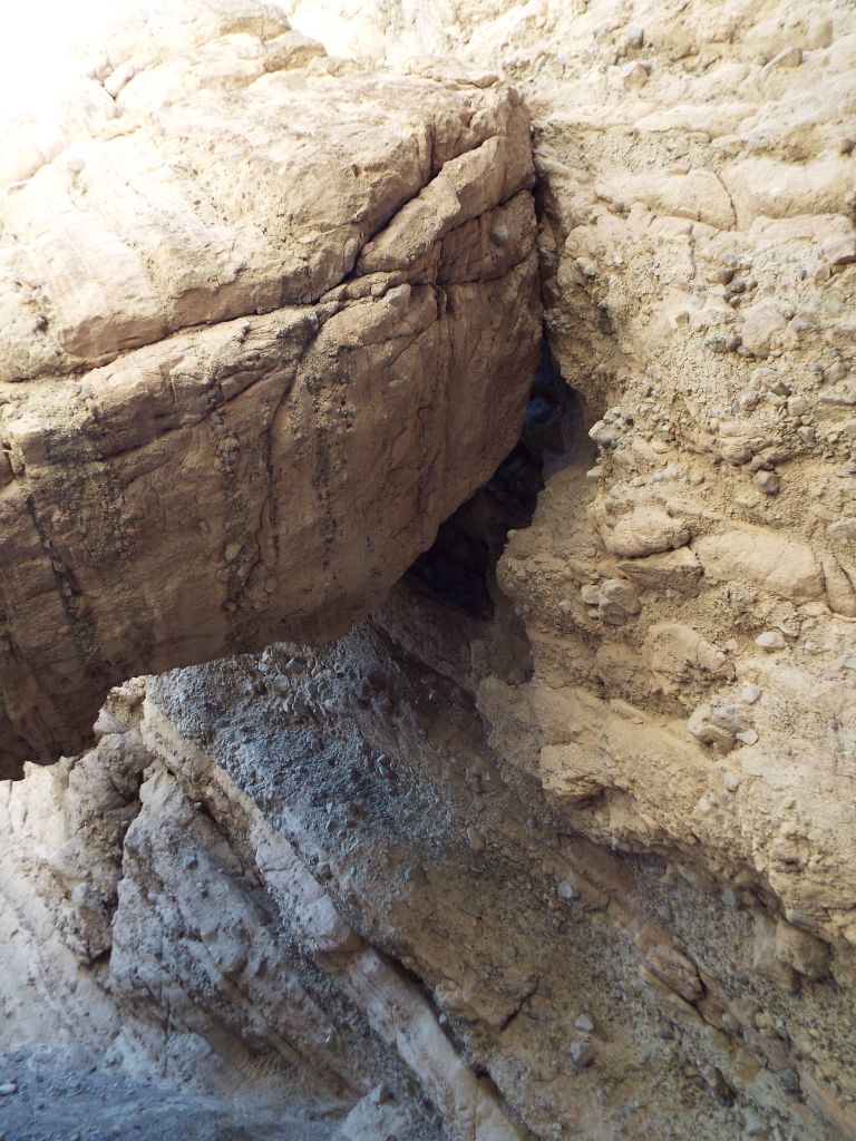 A closer inspection is done in the next two photos which determines that this is a false natural bridge.  It is probably a collapsed canyon wall or oblong boulder which fell into the canyon: