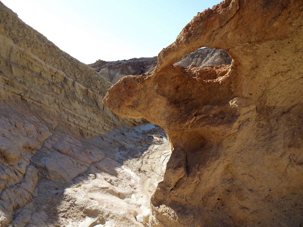 This canyon wall has a natural window to look through: