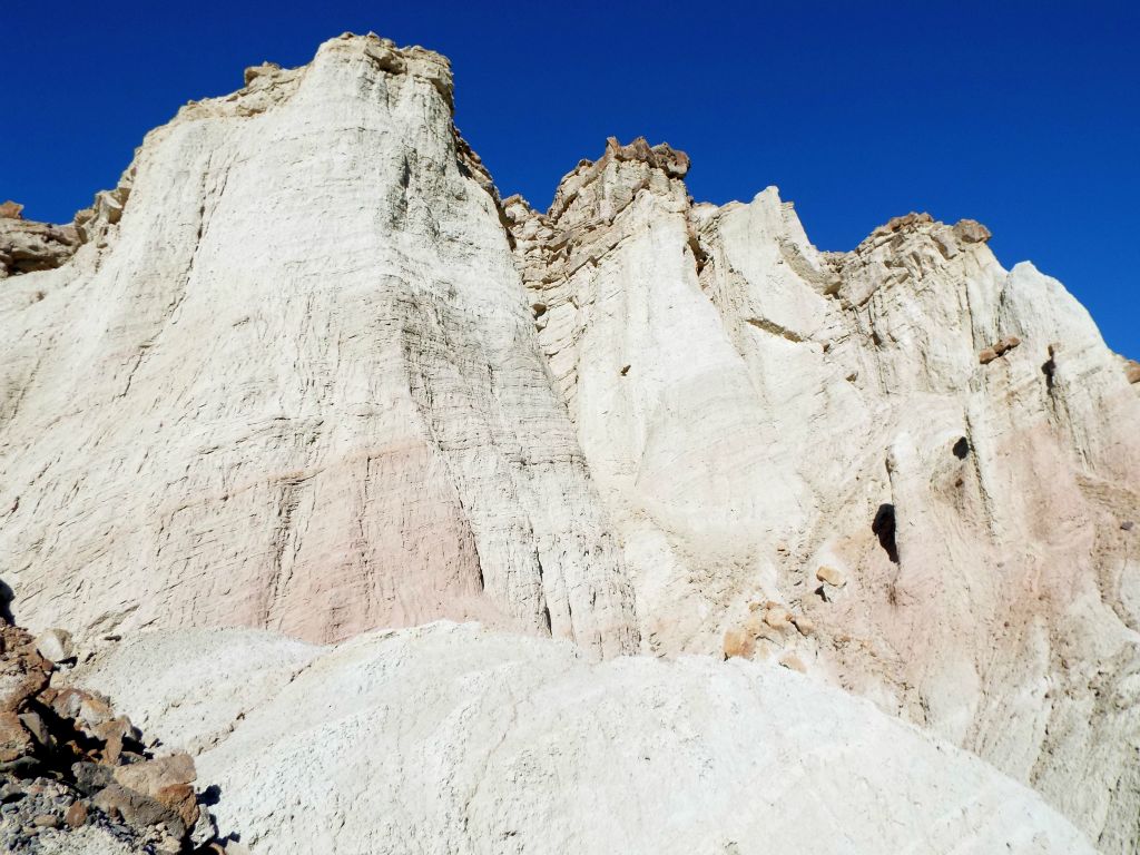 Huge vertical cliffs rose up above the pinnacles: