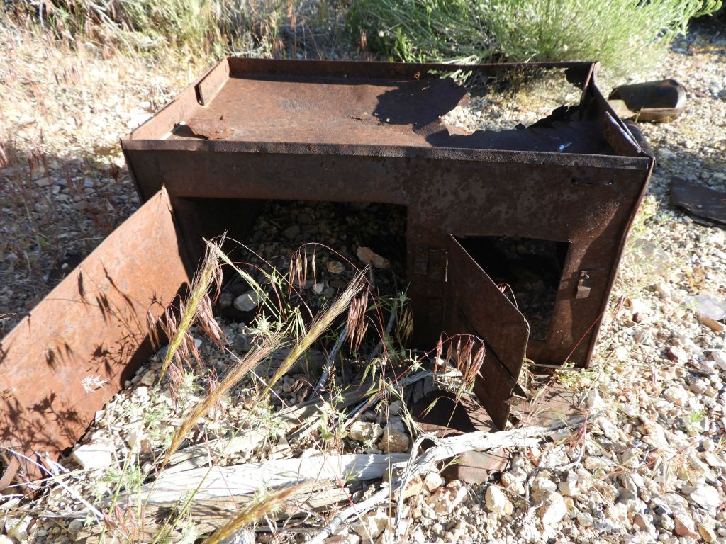 This looks like it is possibly an old oven that was once used by miners to warm up their food: