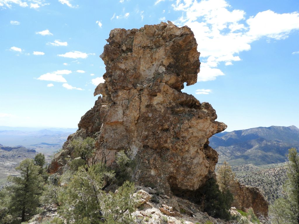 Looking back, the rock crags tower up high above the top of the ridge: