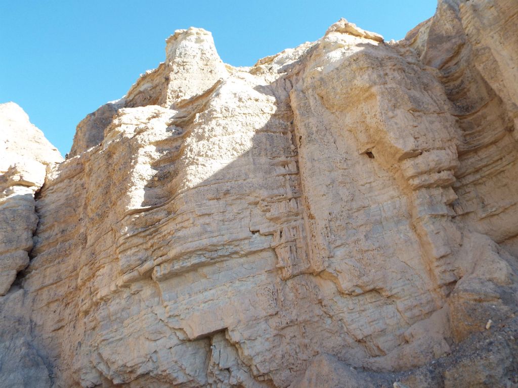 The formations include mini pinnacles and tilted layers of rock with diagonal lines: