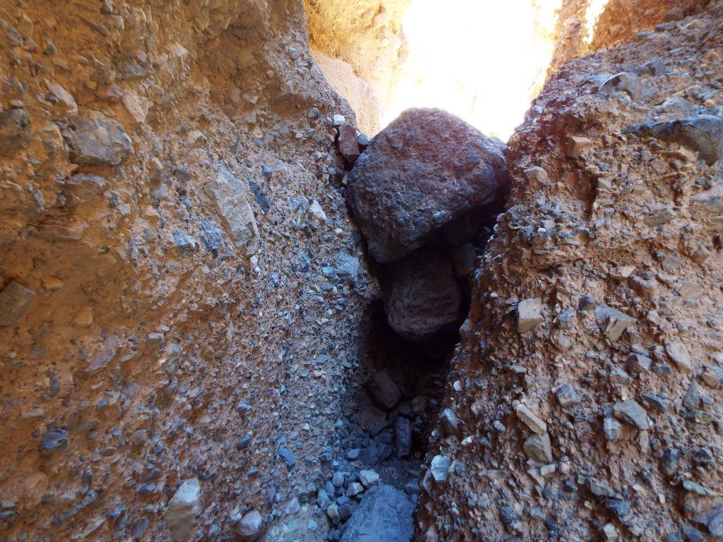 To get down the dry fall, I used counter-pressure with my feet pressed firmly against both walls.  It wasn't easy but it worked:
