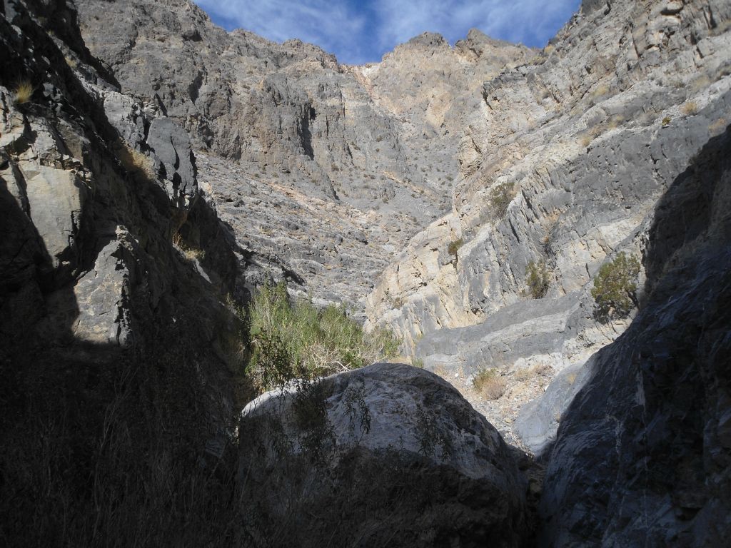 Note the contrast of being in such a small and narrow place while looking up at the surrounding towering walls and mountains: