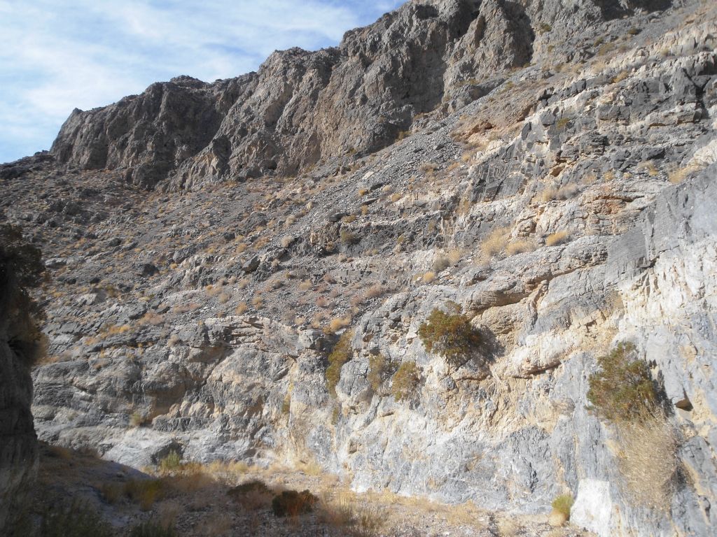 Shallow narrows give way to dirt hillsides rising up high: