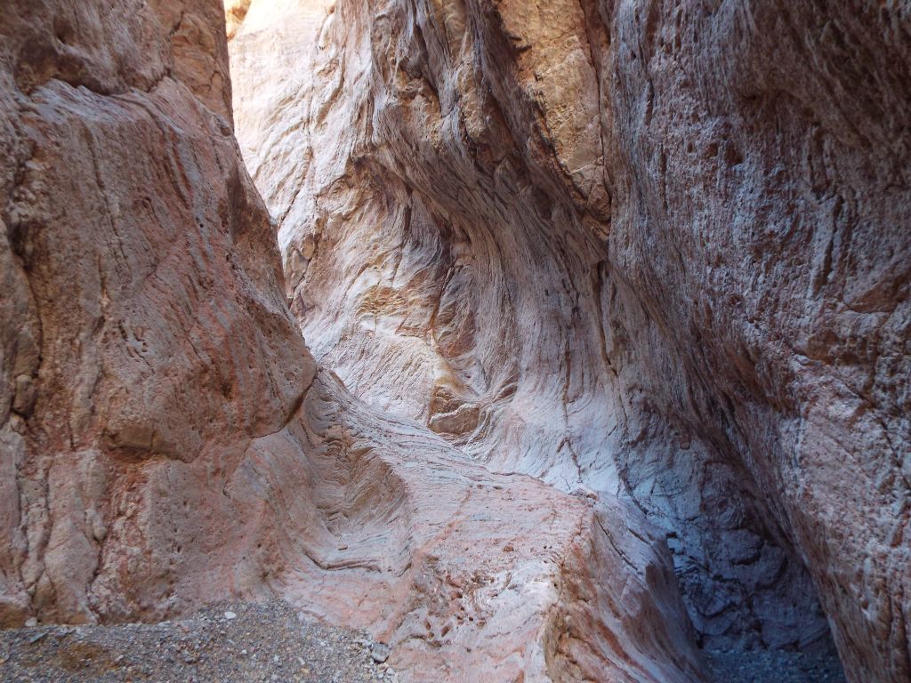 The landscape view of this same spot reveals a polished chute which curves up the canyon wall: