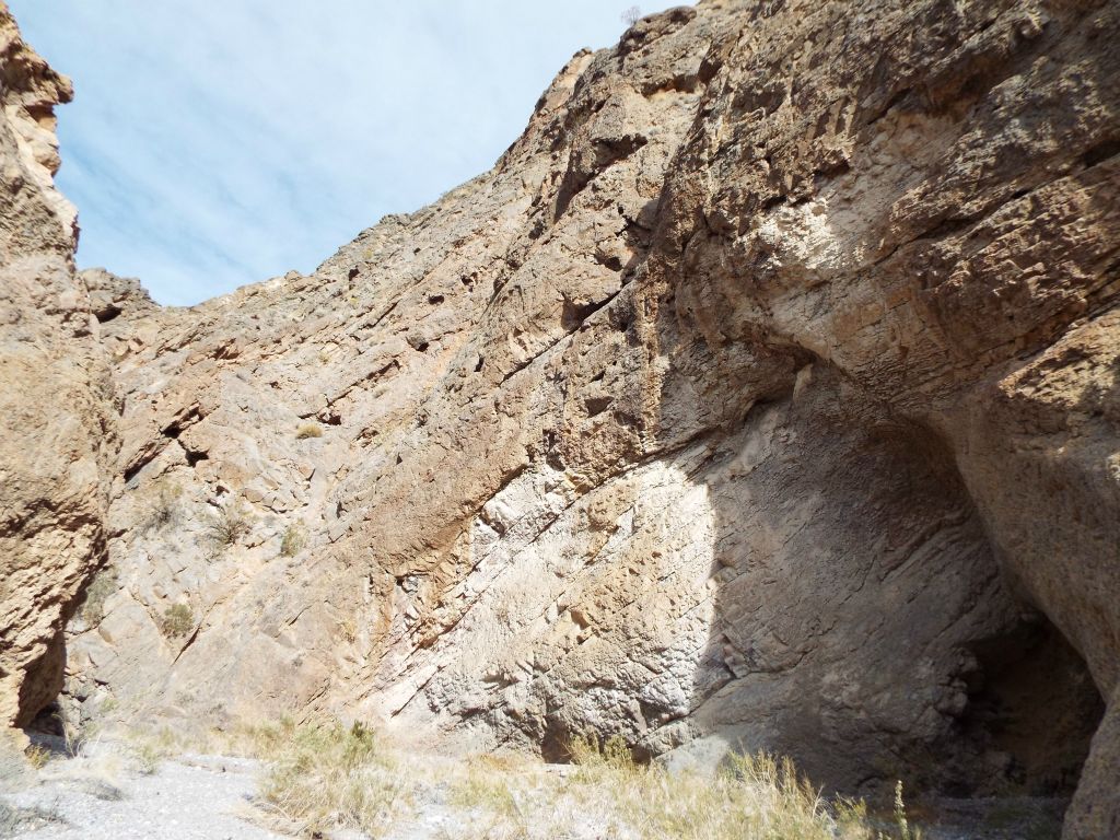 Note the deep cave within the right side canyon wall: