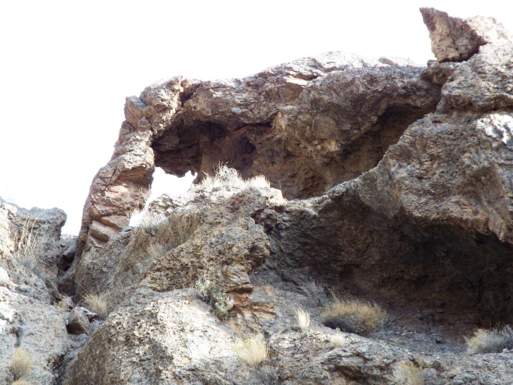 A rock arch can be spotted along the canyon rim: