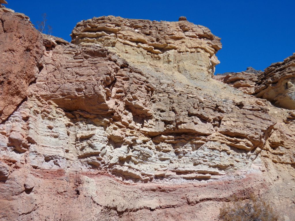 A variety of rock layers on display in the canyon wall: