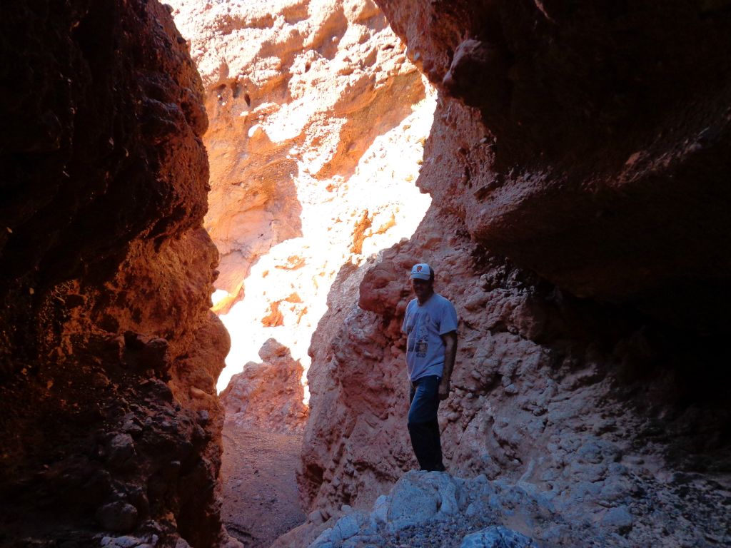The cave is off to the right of where Steve is standing: