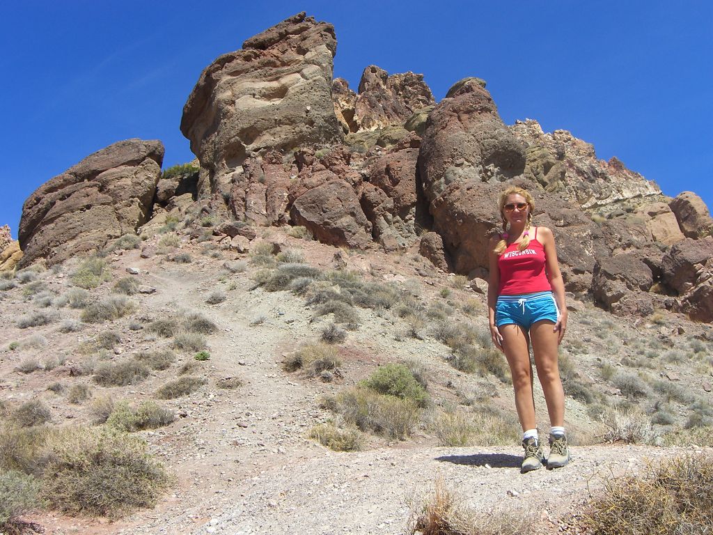 Daria posing at Red Pass with some unusual rock formations behind her: