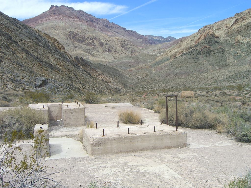 Remains of a concrete pad with the sides and roof completely missing: