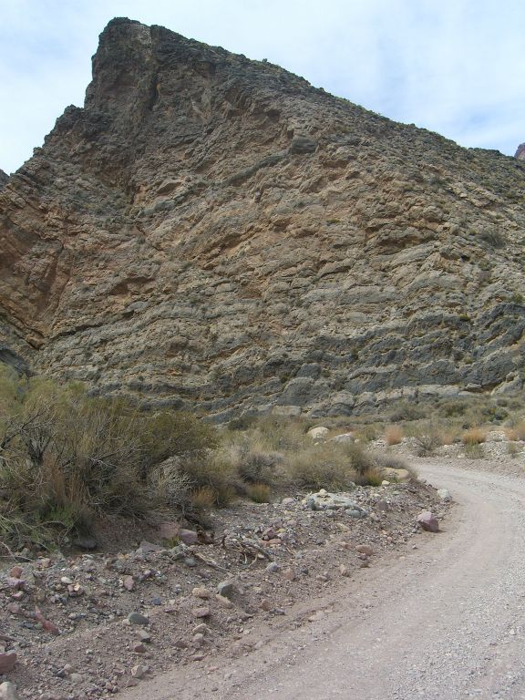 About 1/3 of a mile driving past Leadfield, this triangular peak of bending rock is passed: