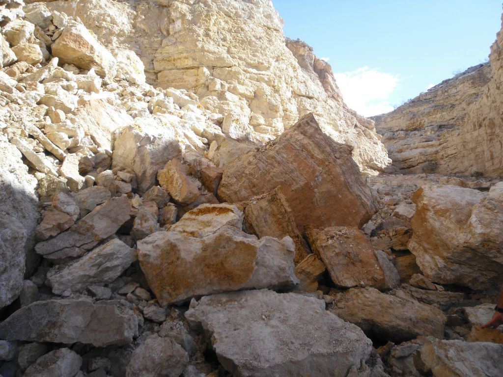 A landslide of rocks and boulders which has poured out into the canyon wash: