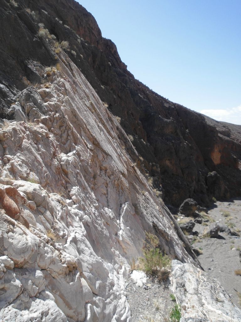 The white rock of the slickenside extends over and above the dry fall for a short distance: