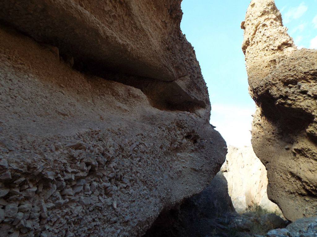 Beautiful conglomerate rock walls with a tall rock pinnacle on the right side: