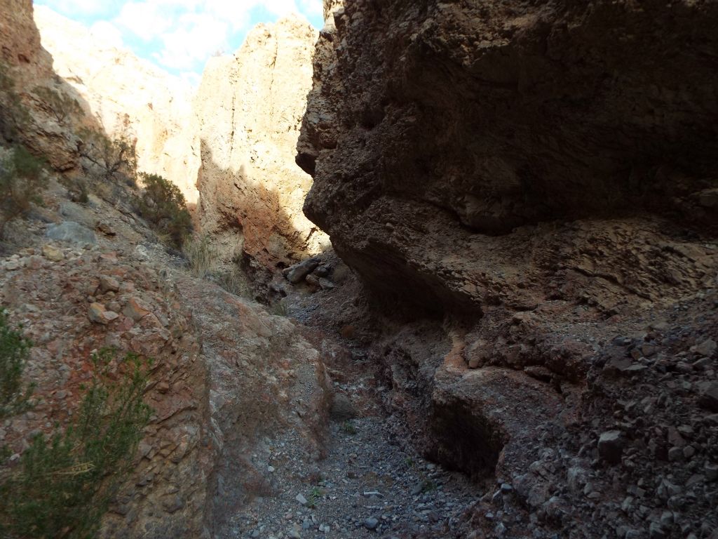 A small narrow passage that water flow has carved through the rock of the canyon: