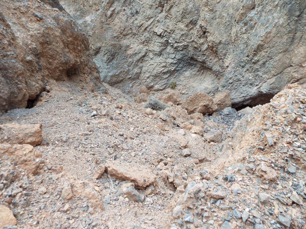 Looking down the rockslide, you can see how the rocks and dirt have filled in a very steep part which might have been a major dry fall at one time: