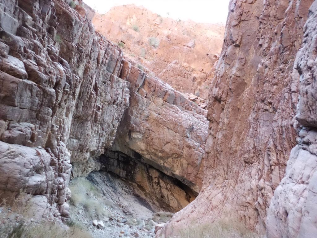 Up ahead there was a black stained undercut or small cave where the canyon took a sharp right: