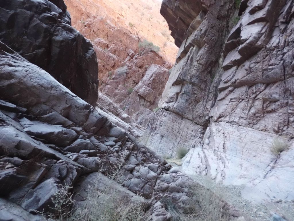 Very pretty section of dark purple rock.  Notice, too, the brilliantly shining light colored rock at the base of the right side of the canyon: