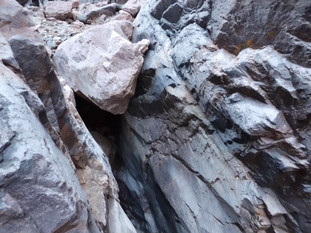 Looking back at the top of the 3rd dry fall from along the ledge.  You can see that it is topped with a massive chockstone.  Only climbers can get down this: