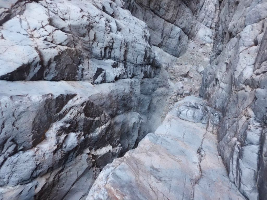 Carefully inching down a small ledge on the right side of the 3rd dry fall to get some pictures:
