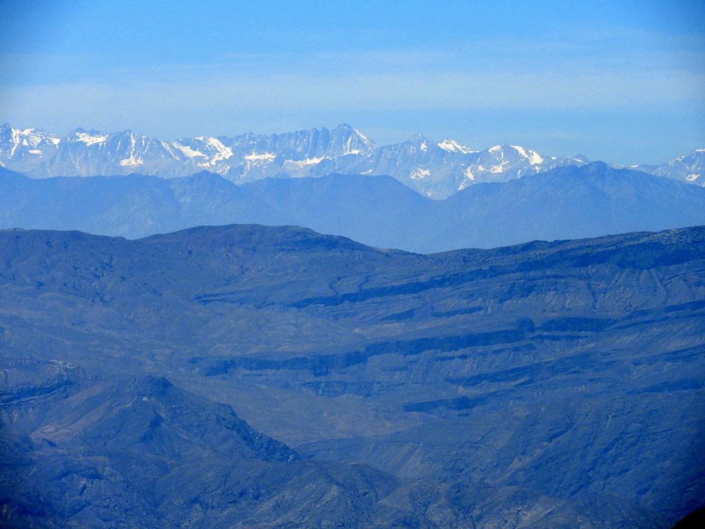 Zooming in on the prominent Sierra peaks above the Lone Pine area.  Starting at the center and heading right, they are Mount Whitney, Mount Russell (14,088 feet), and Tunnabora Peak (13,563 feet):