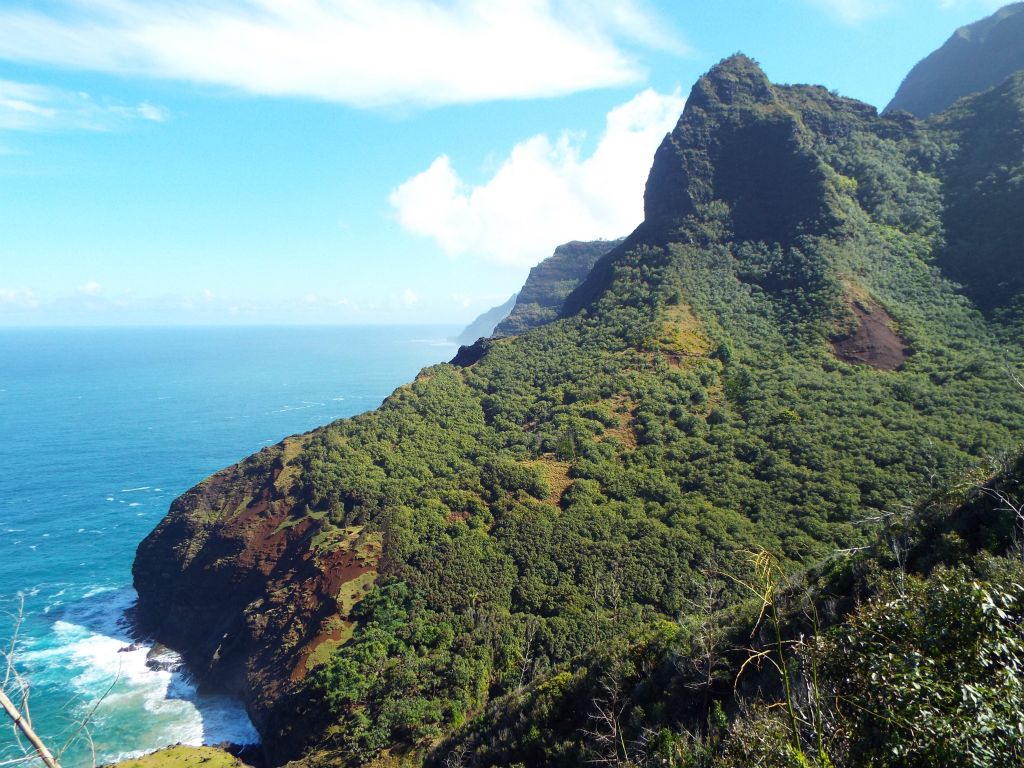 Impressive bare cliffs at the bottom of Hanakoa Valley dropping down to the ocean: