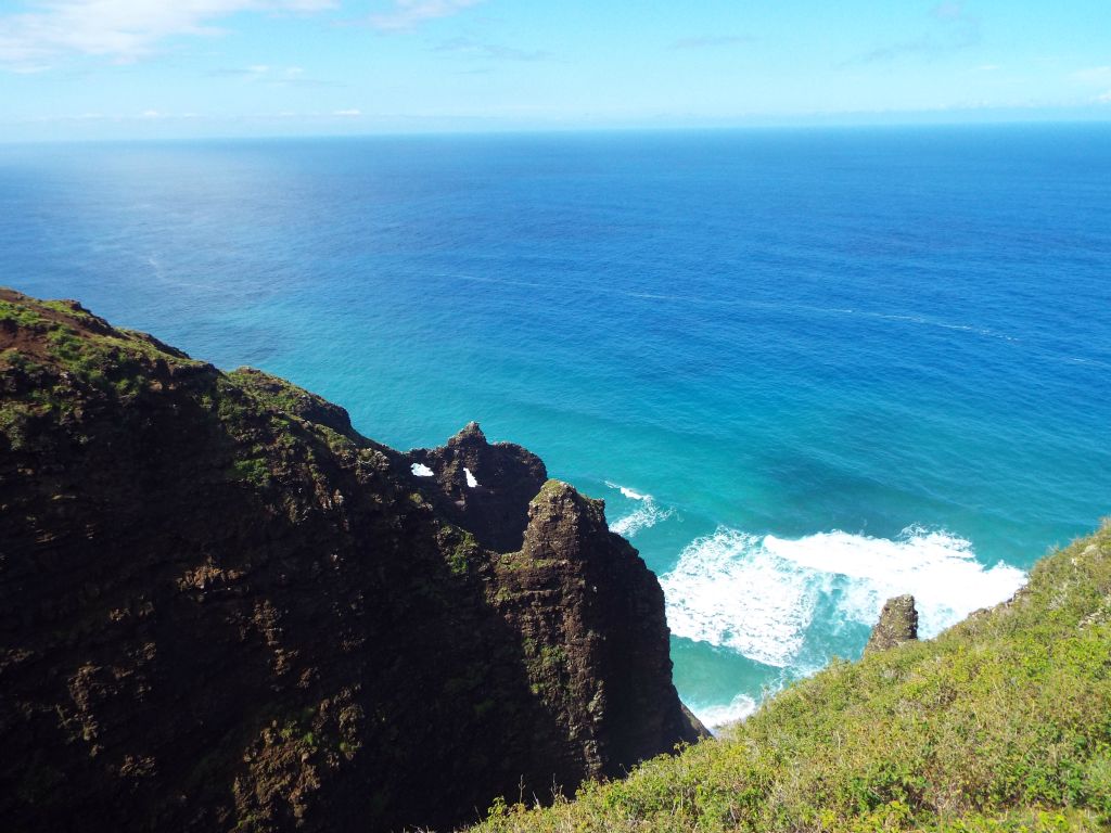 The ocean was a beautiful blue color with many spots where the waves were rough just off the coast: