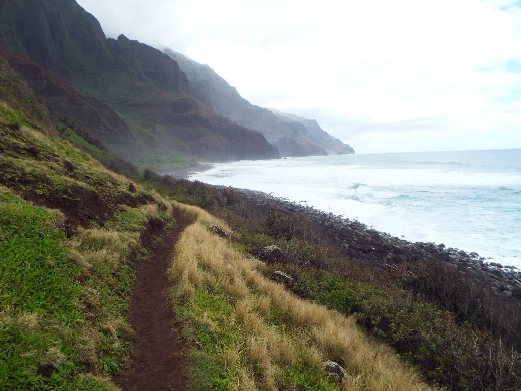 The trail follows close to the rocky part of the beach as it heads for the sand: