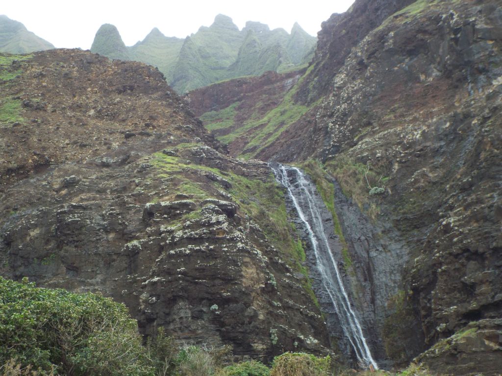 The Kalalau Trail officially ends at this waterfall at the far end of the beach: