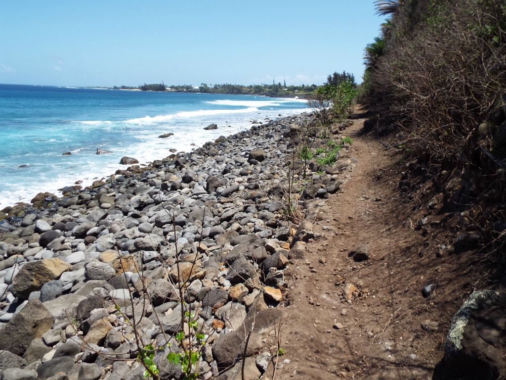 The trail is just above the beach lined with abundant boulders: