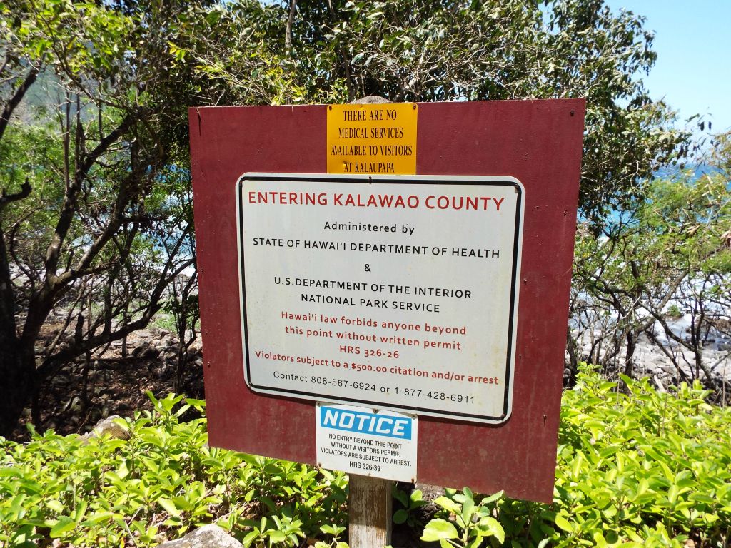 At the end of the trail, you enter into Kalawao County.  A sign reminds hikers of the fines awaiting trespassers without permits: